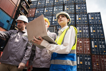 Caucasian woman logistics workers working with man worker at container site