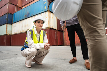 Female worker in a high-visibility sit at container site