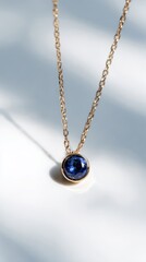 Fototapeta premium Gold Chain Blue Gemstone Pendant Necklace
