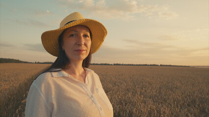 A Woman in a Wheat Field at Sunset, with radiant colors lighting up the serene landscape