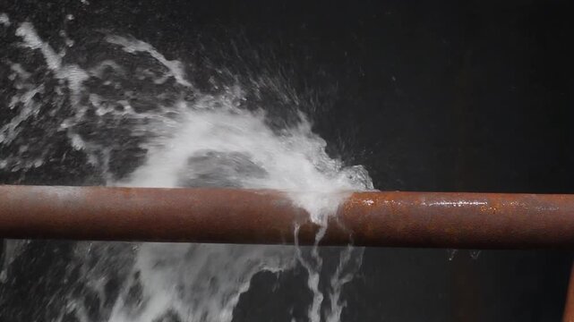 Water pipe damage with a strong stream of water spraying out under pressure