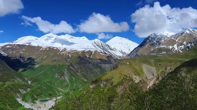 GUDAURI, GEORGIA - APRIL 26, 2024: Scenic view of the Devil's Gorge and the Arch of Friendship. The Caucasus Mountains in the area of the Peoples' Friendship Arch on the Georgian Military Road. 4K
