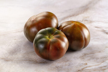 Ripe black juicy tomato cumato