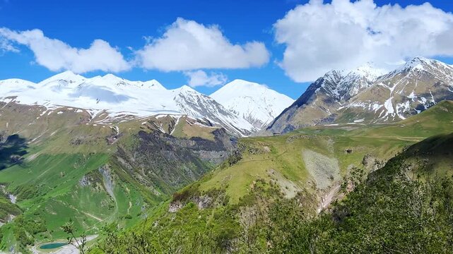 GUDAURI, GEORGIA - APRIL 26, 2024: Scenic view of the Devil's Gorge and the Arch of Friendship. The Caucasus Mountains in the area of the Peoples' Friendship Arch on the Georgian Military Road. 4K