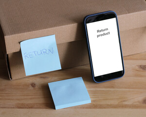 Online product return process with smartphone and cardboard box
