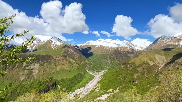 GUDAURI, GEORGIA - APRIL 26, 2024: Scenic view of the Devil's Gorge and the Arch of Friendship. The Caucasus Mountains in the area of the Peoples' Friendship Arch on the Georgian Military Road. 4K