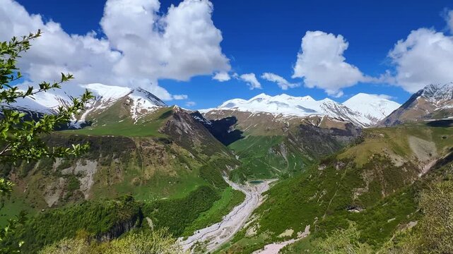 GUDAURI, GEORGIA - APRIL 26, 2024: Scenic view of the Devil's Gorge and the Arch of Friendship. The Caucasus Mountains in the area of the Peoples' Friendship Arch on the Georgian Military Road. 4K