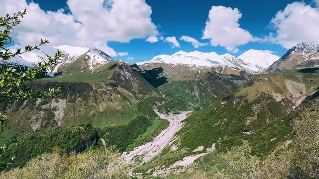 GUDAURI, GEORGIA - APRIL 26, 2024: Scenic view of the Devil's Gorge and the Arch of Friendship. The Caucasus Mountains in the area of the Peoples' Friendship Arch on the Georgian Military Road. 4K