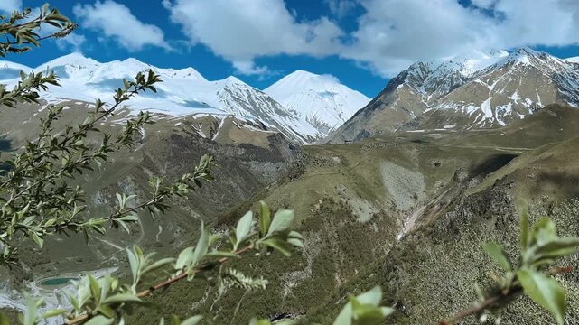 GUDAURI, GEORGIA - APRIL 26, 2024: Scenic view of the Devil's Gorge and the Arch of Friendship. The Caucasus Mountains in the area of the Peoples' Friendship Arch on the Georgian Military Road. 4K