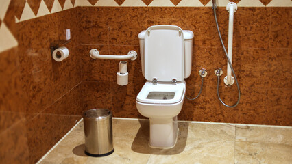 Accessible restroom with grab bars wall.