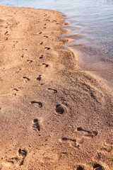 Footprints on the seashore, a symbol serenity and a long-awaited vacation.