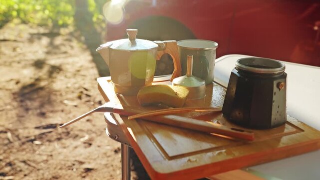 Simple outdoor coffee making scene with metal pot and tools in calm nature