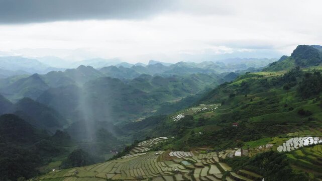 Mộc Ch&acirc;u storm cell through a static drone shot featuring a slow camera tilt-down, revealing the rapid surge of plateau rapids amidst region terraced agriculture in Sơn La Province, Northwest Vietnam.