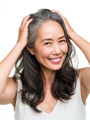 Naklejka premium portrait of gorgeous happy middle aged mature asian woman senior older 50s lady pampering her hair looking at camera isolated on white ads of anti age skin and hair care spa copy space no logos no br
