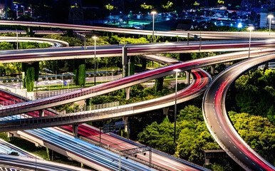 Illuminated Highway Interchange with Light Trails at Night