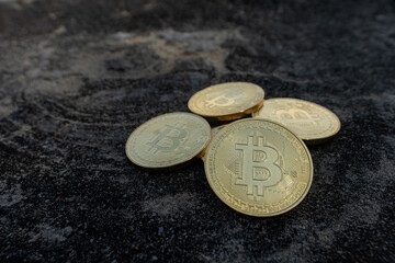 Golden Bitcoin Coins on Dark Stone Background, Cryptocurrency Investment Concept