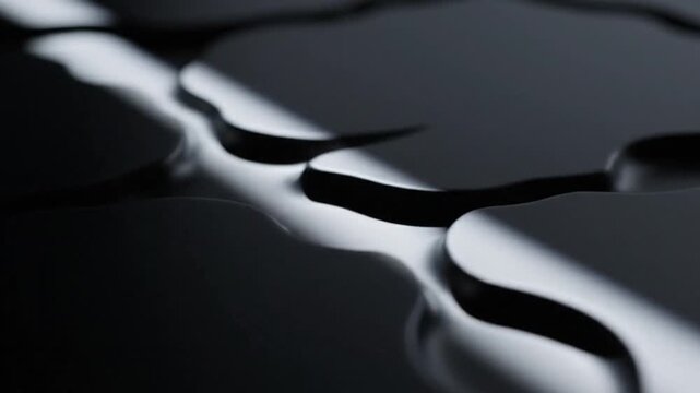 Close-up of a jigsaw puzzle pieces with reflective surfaces against a dark background with shallow depth of field.