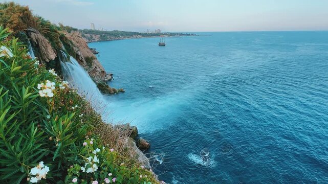 View of the Nizhny Duden waterfalls in Antalya, Turkey. Waterfalls fall from a rocky cliff into the Mediterranean Sea. The cascade is formed by the Duden River, one of the rivers in southern Anatolia.