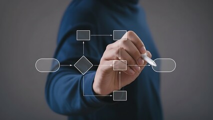 Person drawing a flowchart with white outlined shapes and arrows