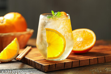 Refreshing spritzer cocktail with mint on wooden table, closeup