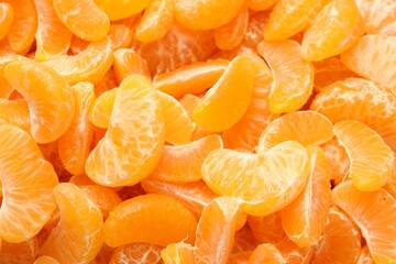 Many ripe peeled tangerines as background, top view
