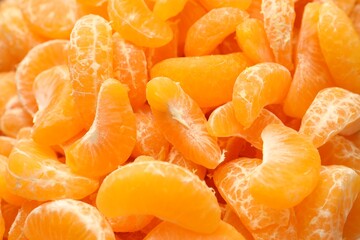 Many ripe peeled tangerines as background, top view