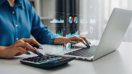 Businesswoman working on laptop with calculator and graphs in office setting with financial data