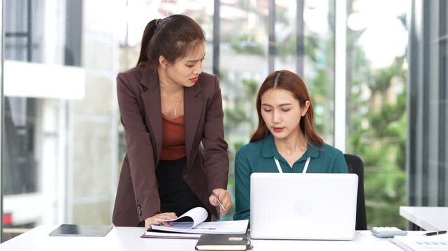 Chief and subordinate talking at workplace, dissatisfied boss points on rude mistakes on report criticizing work scolding accusing young female employee. 