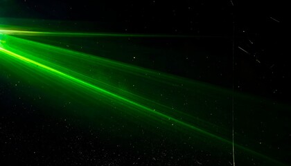 Bright green beam of light streaking across dark cosmos-like background