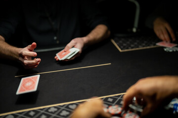 Professional casino poker dealer dealing playing cards to players at felt table, capturing regulated card distribution process during live gambling operations