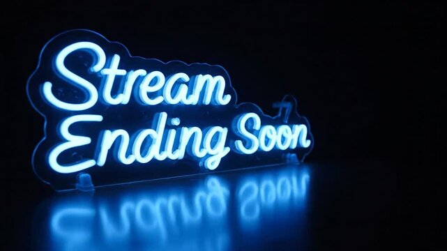 Lit blue "Stream Ending Soon" neon sign on dark surface, reflecting