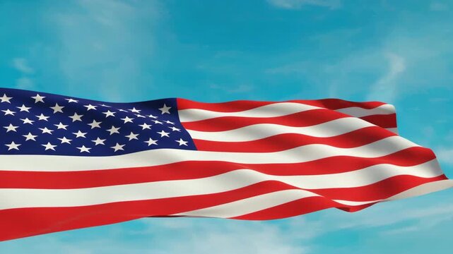 A vibrant American flag flying freely with its stars and stripes fully visible against a clear blue sky background.