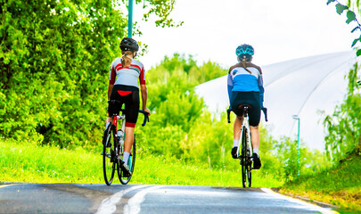 Fototapeta premium Cyclists ride on the bike path in the city Park 