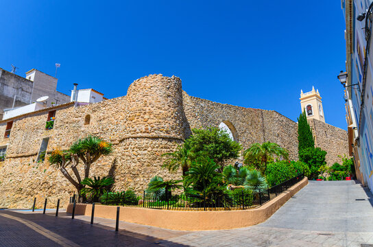 Torreo de la Peca tower and Museum of Collecting Museu del Coleccionisme with stone walls in old town Calpe city historical centre in sunny summer day, Calp Casco Antiguo, province of Alicante, Spain