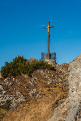 The Bavarian summit cross at the peak of the mountain called Hochfelln which is located at the Chiemgau mountain range 