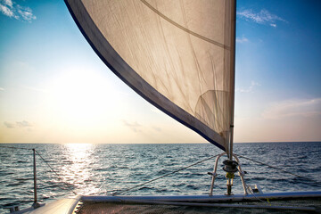 Sailing Boat Deck with White Sails at Sunset Seascape © PhamThi