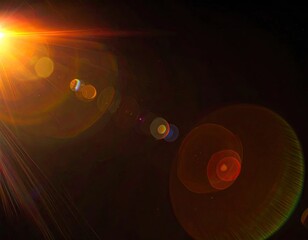 Intense lens flare with bright orange and gold hues against dark