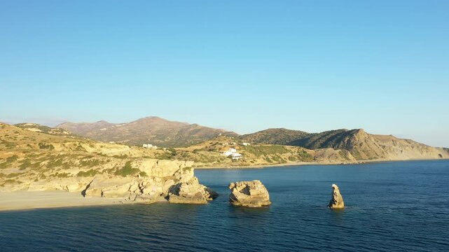 Aerial view of Triopetra Beach with unique rock formations and clear blue sea, set against the rugged coastline of Crete, Greece.