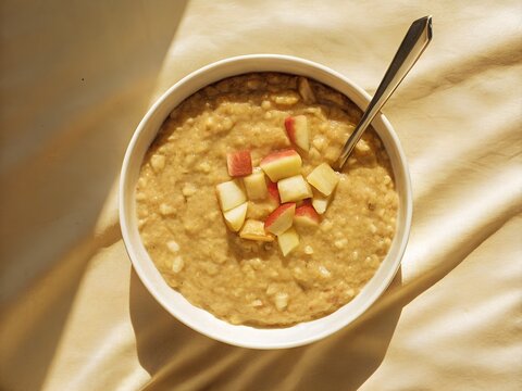 Overhead view of healthy oatmeal porridge with diced apples