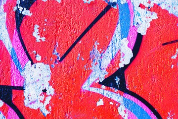 Abstract graffiti texture with red, blue, pink, black colors and peeling paint. 2000s street art, urban decay, vibrant color contrast. Background, texture, pattern, digital art, banner, flyer.