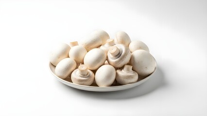 A plate of fresh white mushrooms on a clean white background