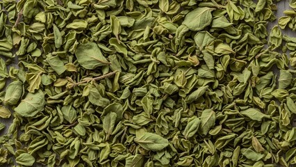 A close-up view of dried green leaves scattered on a surface