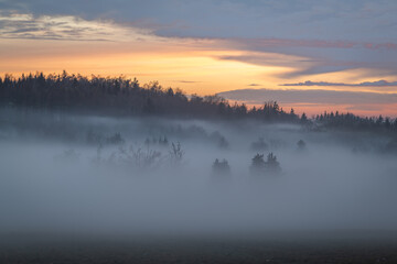Winter sunset with inversion fog from valleys in Nemci village