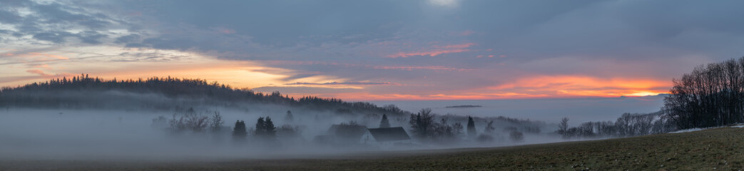 Winter sunset with inversion fog from valleys in Nemci village