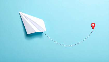 Paper airplane, minimalist flat lay, pastel blue background, curved dashed flight path, red location pin, playful travel concept, creative journey idea