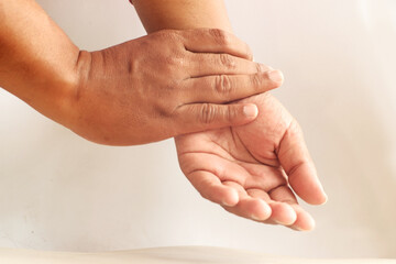 Fototapeta premium Close-Up of Hand Checking Pulse on Wrist