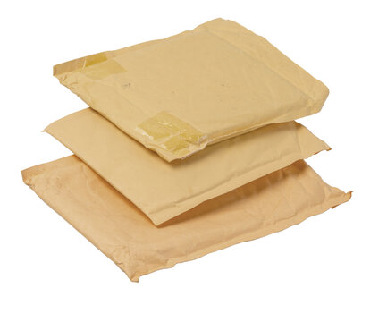 Stack of old padded bubble mailers ready for shipping