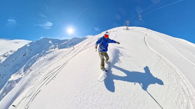 POV action shot of a young man snowboarding downhill while filming with a 360 camera. Sunny winter day, fresh snow, fast movement and outdoor adventure lifestyle in the mountains. Perfect for sports, 