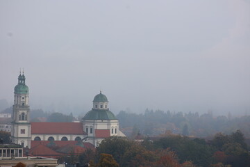 Foggy day with a church and a tower in the background