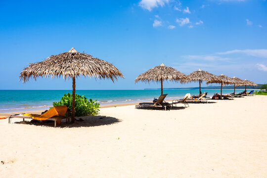 Beach umbrella and sun loungers on tropical beach
